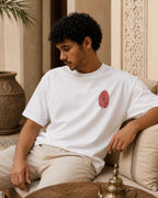 T-shirt blanc MarocGear avec badge rouge marocain, porté dans un décor de riad premium.