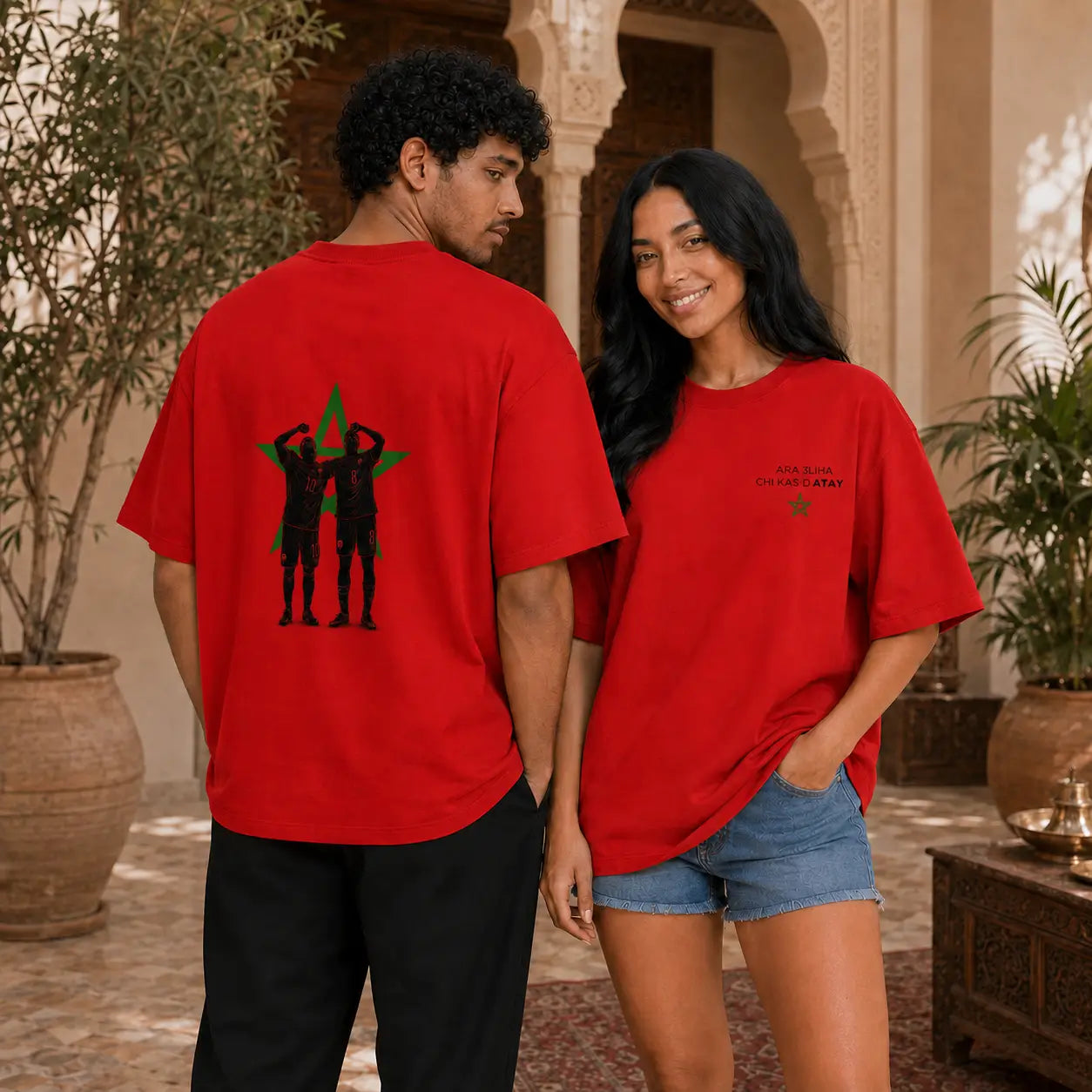 Deux modèles portent le t-shirt rouge MarocGear ATAY dans un riad marocain, avec design supporters du Maroc au dos et logo minimaliste à l’avant.